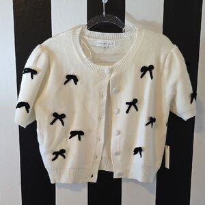 White Cardigan with Black Bow Accents